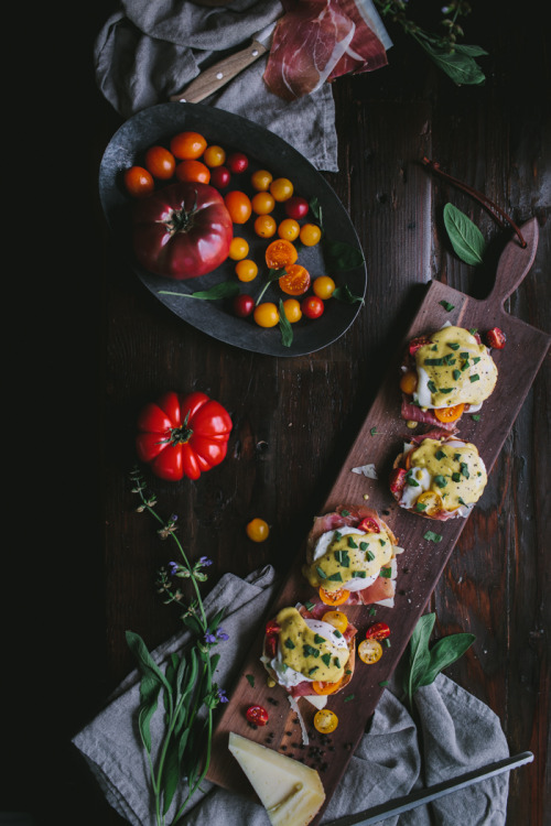Eggs Benedict With Manchego, Tomatoes, Prosciutto & A Sage Hollandaise SauceSource